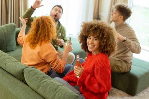 Four friends gather in a cozy living room, sharing laughter and drinks while seated on a comfy sofa. The atmosphere is warm and inviting, perfect for enjoying each other's company.