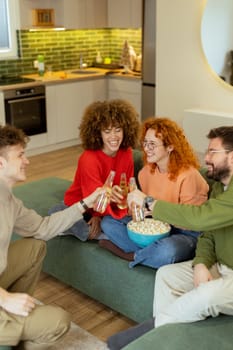 Friends gather in a stylish living room, raising glasses filled with refreshing drinks. They share laughter and warmth while surrounded by a bowl of popcorn, creating joyful memories