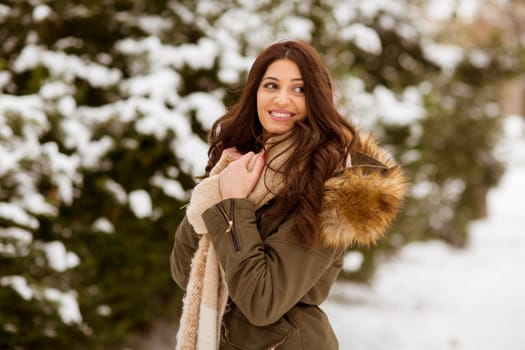 Portrait of young woman in winter park