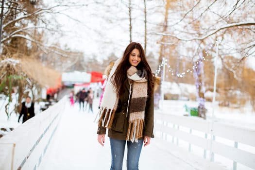 Portrait of young woman rides ice skates in the park