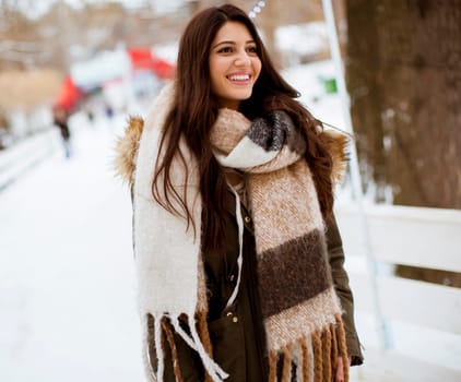 Portrait of young woman in winter park