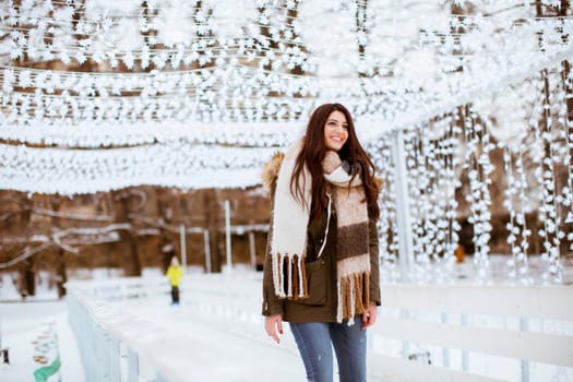 Portrait of young woman in winter park at Christmas market