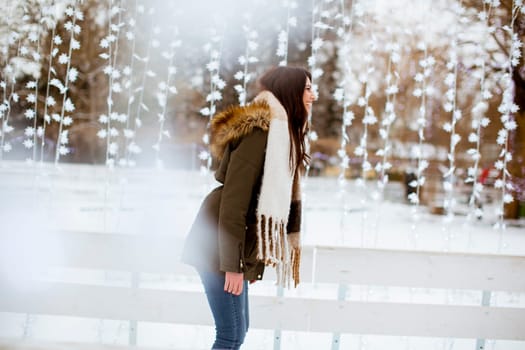 Portrait of young woman rides ice skates in the park