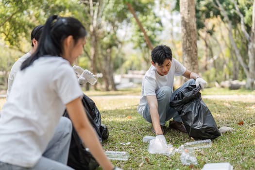 A group of volunteers actively participating in a cleanup event, gathering trash in a beautiful park.