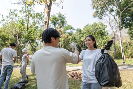 Volunteers celebrate their achievements during a cleanup event, showcasing teamwork and commitment to a cleaner environment.