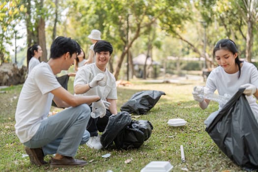 Volunteers sort through collected trash in a park cleanup, highlighting their commitment to sustainability and teamwork.