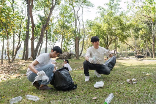 A group of volunteers actively participating in a cleanup event, collecting waste and promoting sustainability in a natural setting.