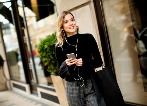 Portrait of young woman  listening music outdoor