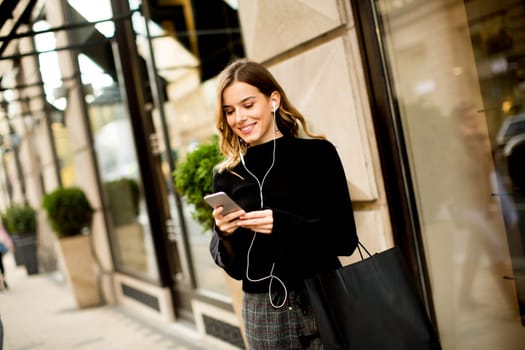 Portrait of young woman  listening music outdoor