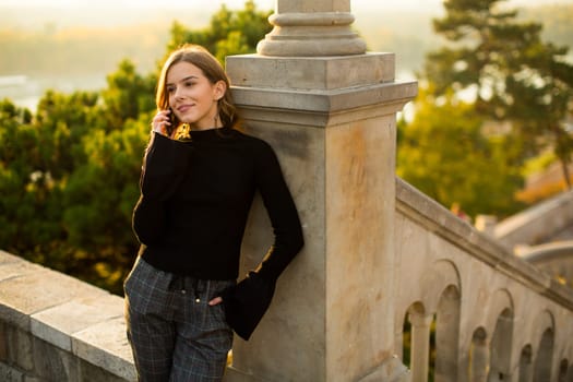 Portrait of young woman with mobile phone outdoor