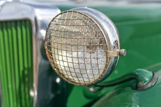 Close up green vintage car chrome rusty side mirror