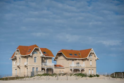 Two charming houses in Biscarosse stand close to the coastline, facing potential danger from rising tides and erosion, highlighting the vulnerability of coastal living.