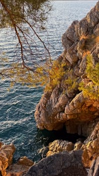 Harsh golden cliffs rise above the turquoise waters.