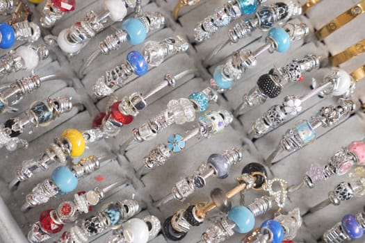 A variety of vibrant bracelets are neatly arranged in a display case.