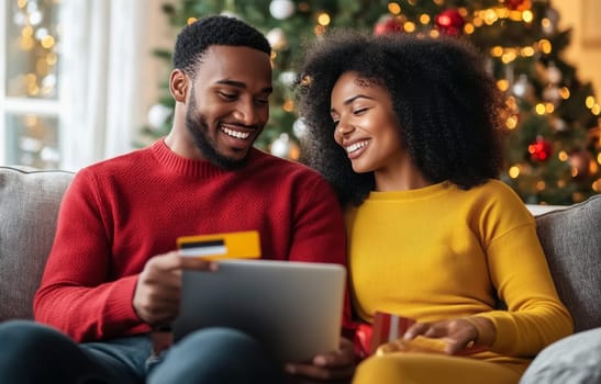 A couple sits close on the couch, smiling and engaged in online shopping, with festive Christmas decorations in the background.