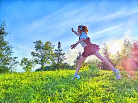 A child runs freely across a lush green field as the sun sets, creating a vibrant and joyful atmosphere.