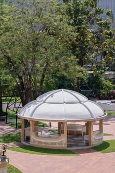 Bangkok, Thailand - Mar 02, 2025 - Low-angle view of The Music Pavilion with Green trees in the background at The garden outside of Bang Khun Phrom Palace or Bank of Thailand Museum. use it as your Wallpaper, Poster and Space for text, Selective focus.