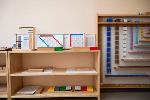 Montessori material. Wooden shelf with materials for Montessori studies