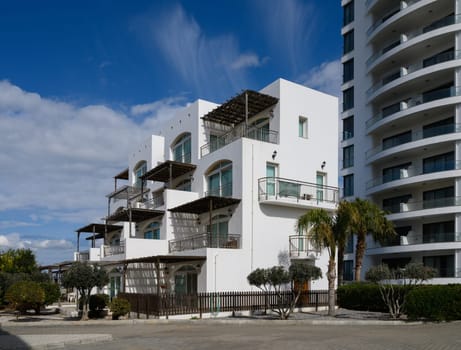 Bright white buildings stand elegantly against a vibrant sky, embodying contemporary style and serene architecture.