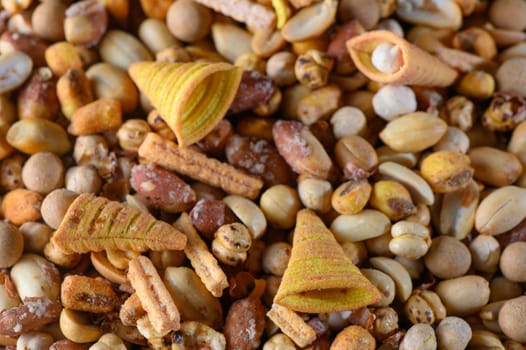 A vibrant mix of crispy snacks lies scattered, showcasing various shapes and flavors perfect for sharing.