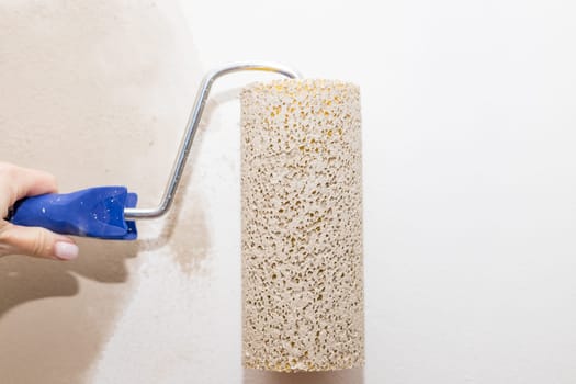 Roller Brush Painting, Worker painting on steel surface wall by the roller brush for protection and corrosion.