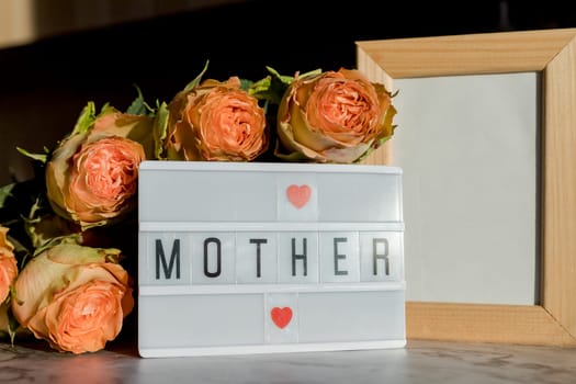 lightbox with quote Happy Mothers day, colorful tulips on pink background. The concept of mother's day.Top view.Flat lay.