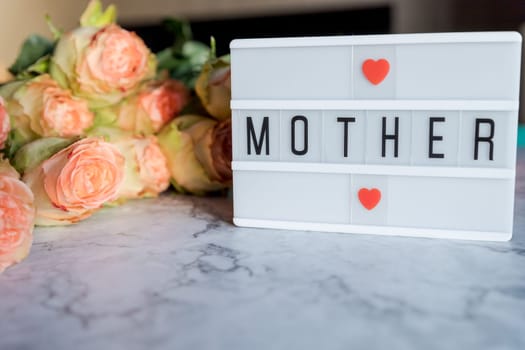 lightbox with quote Happy Mothers day, colorful tulips on pink background. The concept of mother's day.Top view.Flat lay.
