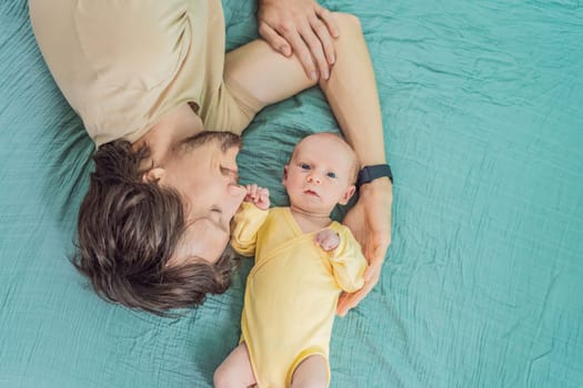 A father and his newborn baby lie on a soft muslin swaddle head to head, sharing a tender moment of closeness and bonding that highlights new beginnings and gentle parenting.