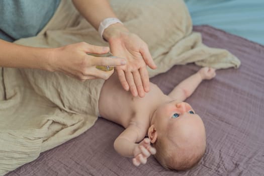 A mother gently massages her 1-month-old baby with baby oil after a bath. This tender moment highlights the bond between parent and child, promoting relaxation, baby care, and the importance of skin-to-skin contact.