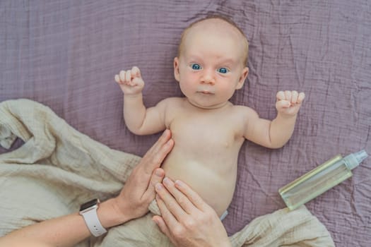A mother gently massages her 1-month-old baby with baby oil after a bath. This tender moment highlights the bond between parent and child, promoting relaxation, baby care, and the importance of skin-to-skin contact.