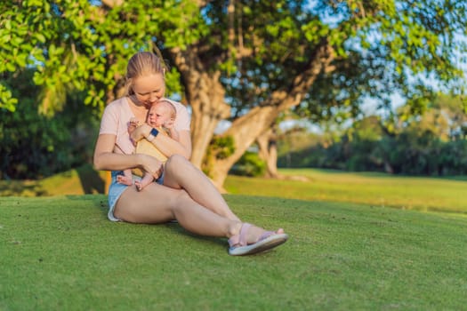 Young mother enjoying a peaceful walk in the park with her one-month-old baby. Motherhood, bonding, and outdoor family time concept.