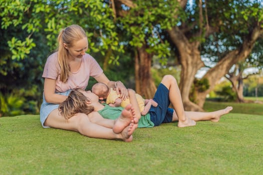 Young mother, teenage son, and one-month-old baby enjoying quality family time in the park. Multigenerational bonding and outdoor family love concept.