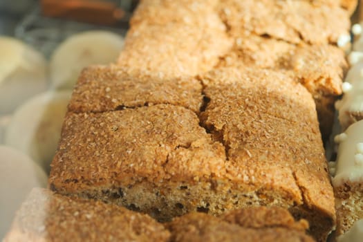 Oatmeal bread is showcased in a bakery, highlighting its texture.