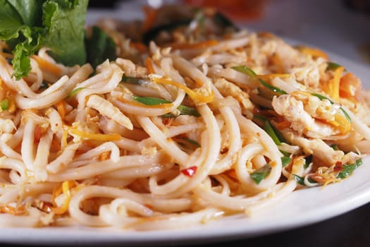 Delicious platter of stir-fried noodles with vegetables and chicken.