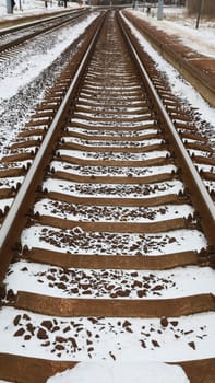 Rails, sleepers covered in snow. Snow-covered railroad.