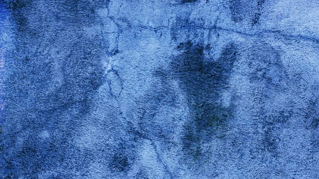 Blue abandoned concrete wall with white spots. Blue abandoned concrete wall with cracks.