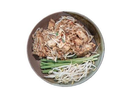 Traditional fried thai noodle (pad thai) mix Stirred fried turnip cake or Fried radish cake (chai tow kway) served with bean sprout and chives in ceramic plate isolated on white background with clipping path. Selective focus.