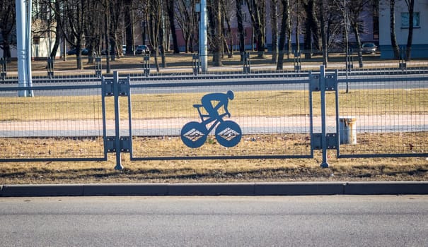 Fence separates two way traffic with decorative sports related ornaments