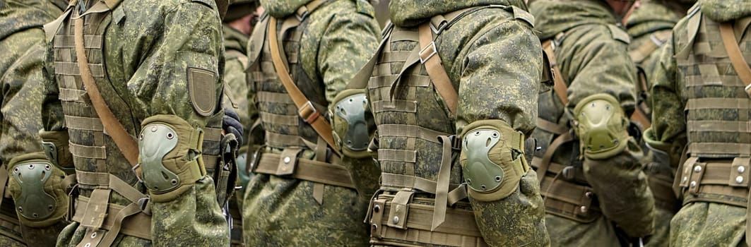 Military personnel engage in a training exercise, showcasing their skills and coordination in tactical formations amidst a clear day.