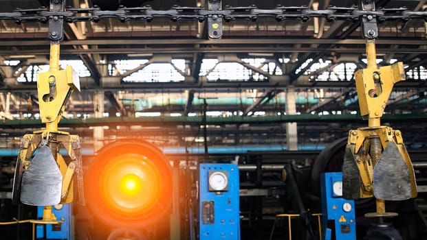 Heavy machinery is actively used for production in a spacious industrial facility, showcasing intense energy and focus during operations.