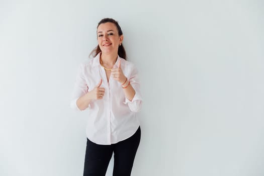 Portrait of a woman of 40 years old in a business suit near a white wall