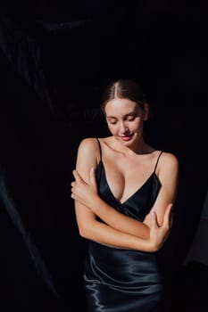 Beautiful woman in summer silk dress on black background