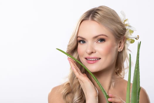 A woman gracefully holds a vibrant and healthy aloe vera plant, which symbolizes natural skincare and overall wellness
