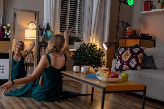 A beautiful, serene evening scene featuring a woman gracefully dancing in a warm, inviting, cozy living room