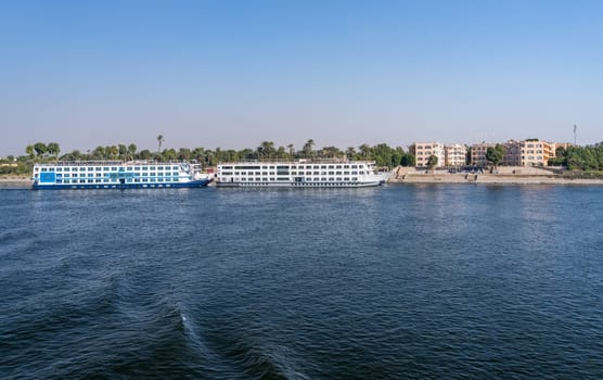 Luxor, Egypt - 2 November 2024: Many Nile River cruise ships are docked alongside each other by Egyptian Experience Resort