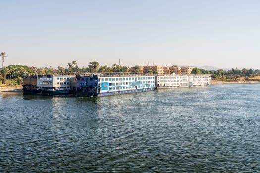 Luxor, Egypt - 2 November 2024: Many Nile River cruise ships are docked alongside each other by Egyptian Experience Resort