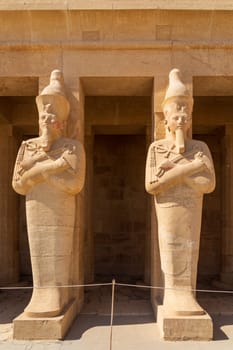 Large statues of two pharoahs at Hatshepsut Temple near Luxor Egypt by the columns of the Mortuary