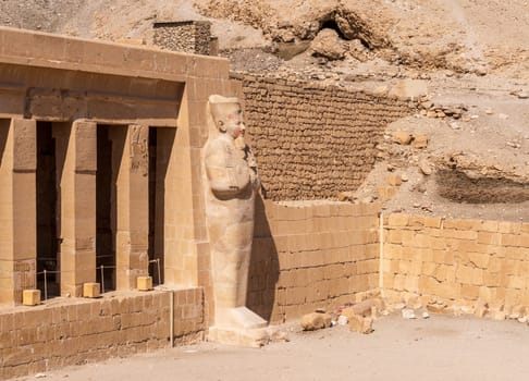 Large statue of pharoah at Hatshepsut Temple near Luxor Egypt by the columns of the Mortuary