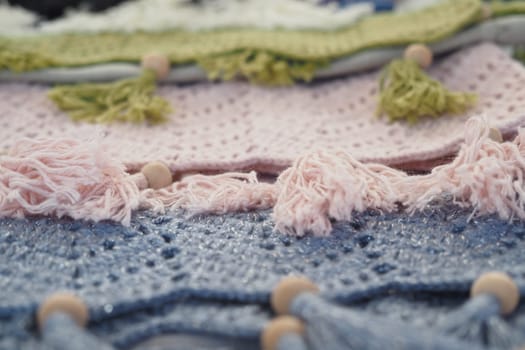 Brightly colored textiles showcase intricate designs and decorative fringes.