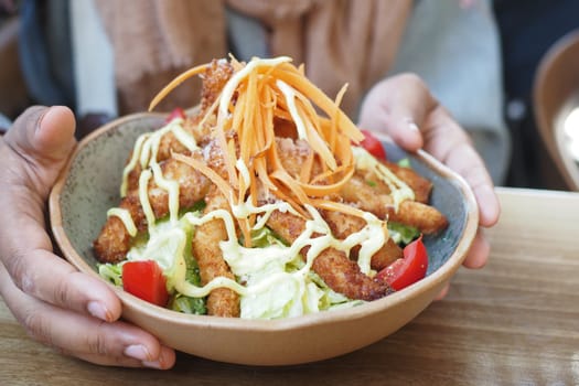 Warm dish features crispy fried items with fresh toppings and sauce.